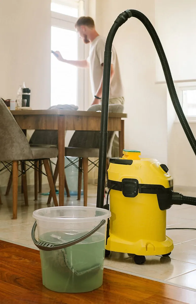 A vacuum cleaner and a bucket during a home clean